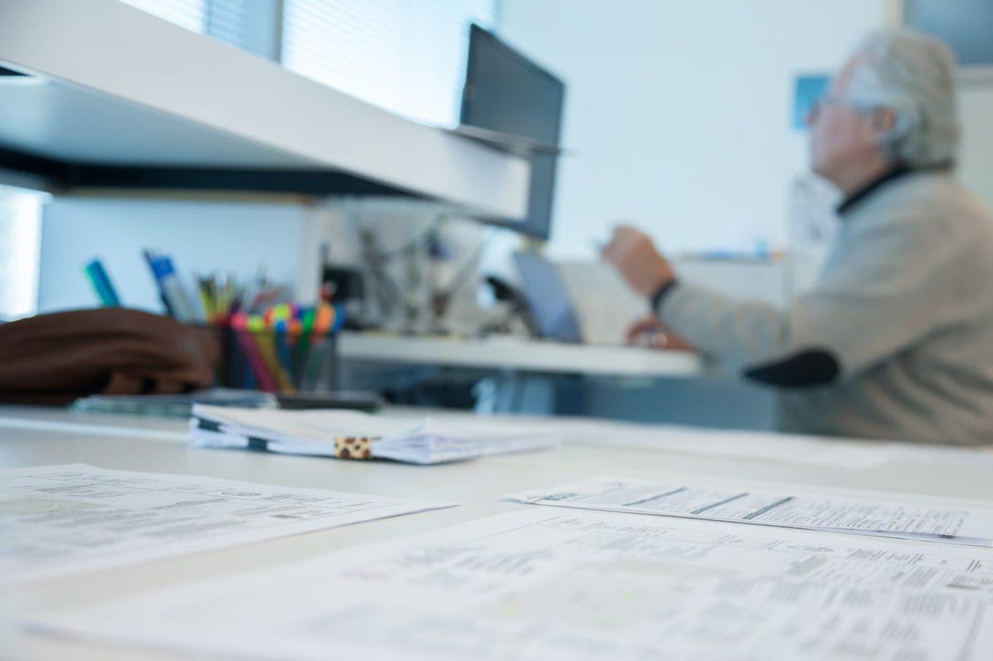 Architectural drawings on a desk in a meeting setting.
